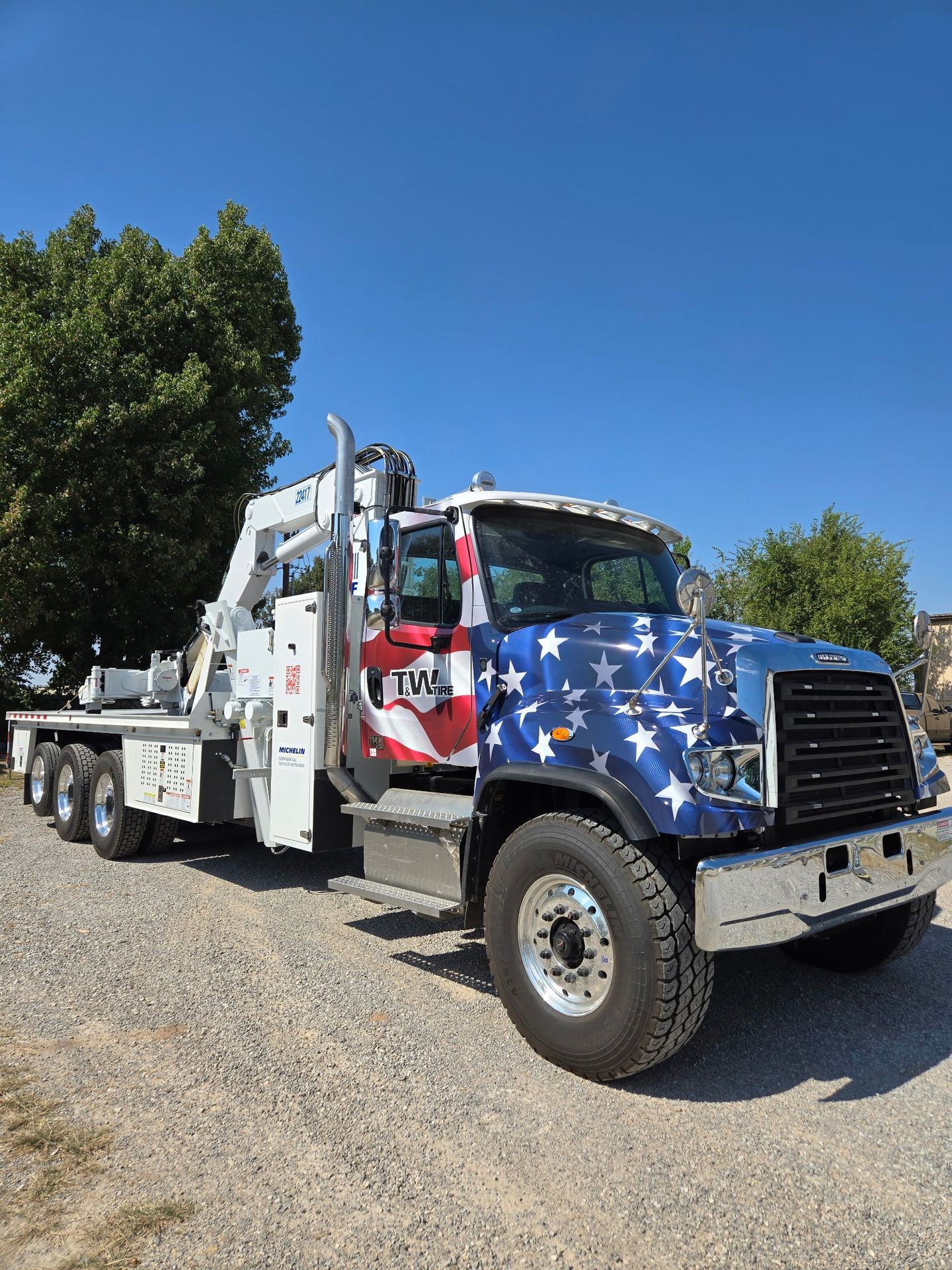 Patriotic custom truck wrap featuring stars and stripes design by Wrapt on a heavy-duty tow vehicle in Oklahoma.